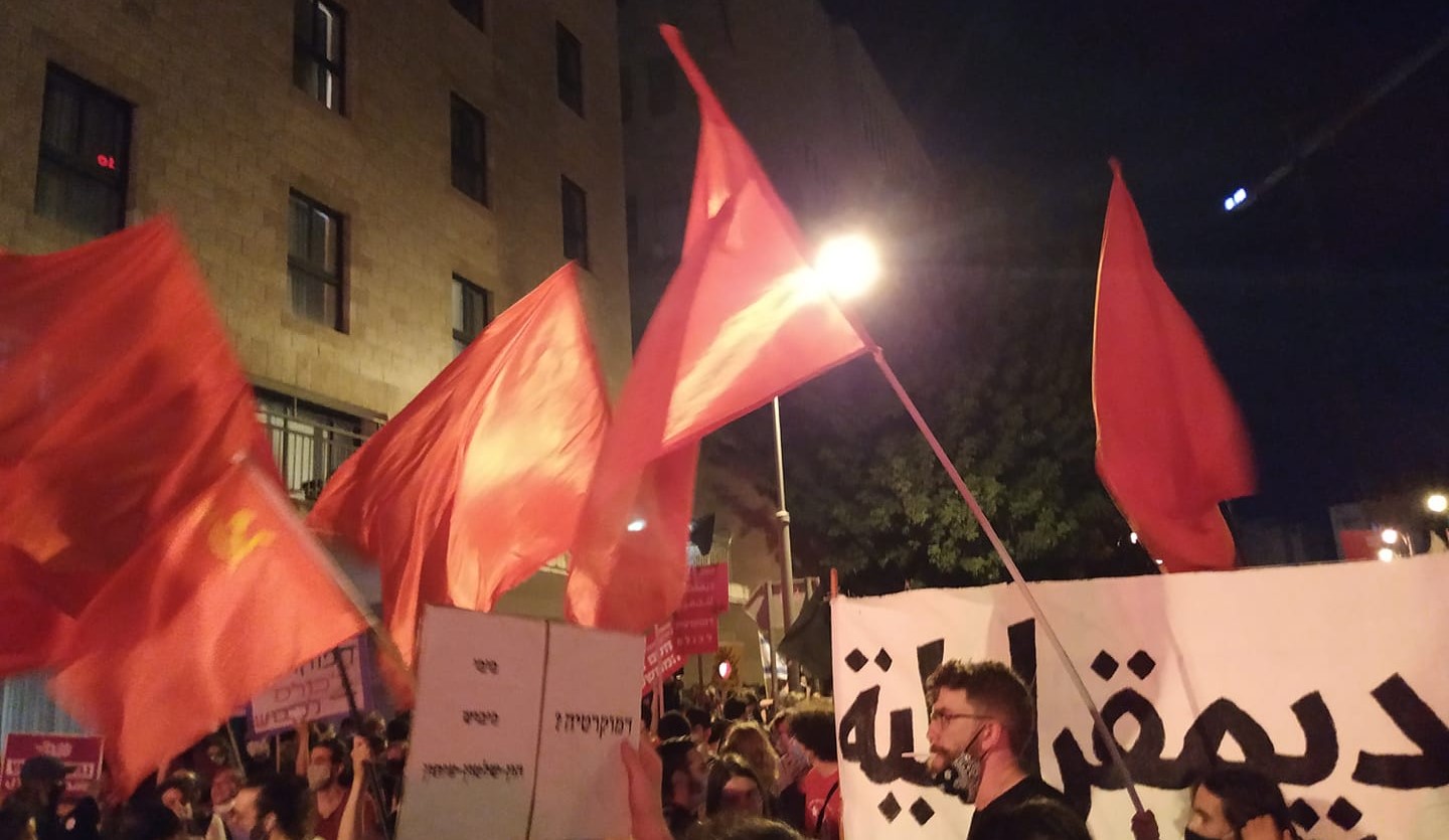Red flags aloft in Jerusalem's Paris Square Saturday night, August 1, near the official residence of Prime Minister Benjamin Netanyahu whose resignation the protestors called for.