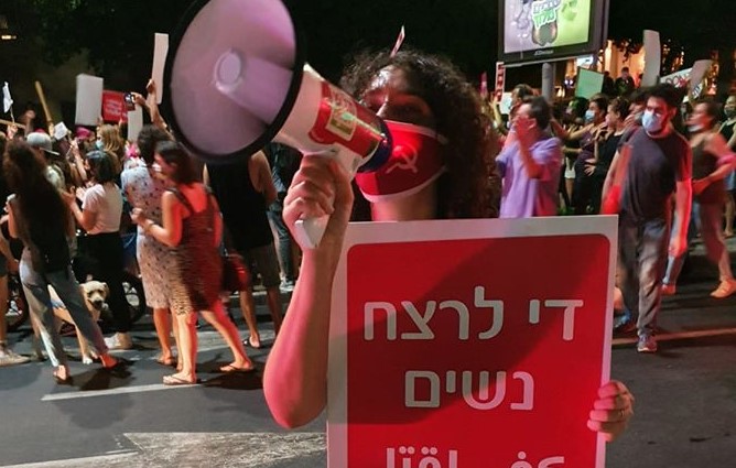 Noa Levy, a member of the Communist Party of Israel's Central Committee during the protest held in Tel Aviv, August 23, 2020. The placard she's holding reads "Enough murder of women."