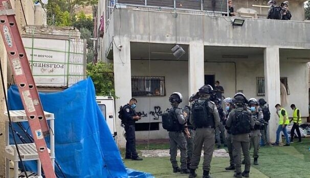 Israeli Border Police deployed to secure the site congregate outside the home in which the Tahan family resided for nearly 30 years in the occupied East Jerusalem neighborhood of Silwan in preparation for its demolition, August 11, 2020.