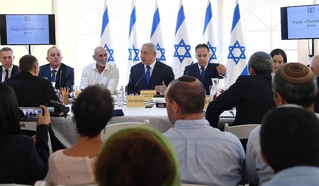 Prime Minister Benjamin Netanyahu leads his cabinet's weekly meeting in the presence of settlers in the occupied Jordan Valley, September 15, 2019.