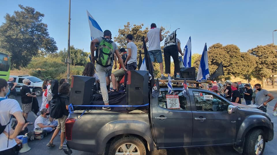 Demonstrators preparing to deploy themselves along a major highway leading to Jersusalem to conduct a protest against Prime Minister Benjamin Netanyahu, Thursday, September 24
