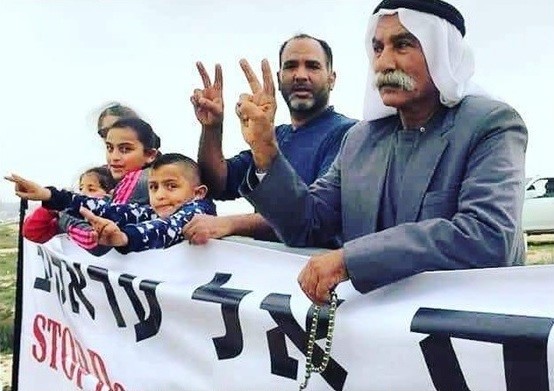 Sheikh Sayekh Abu Madi'am al-Touri, right, and family members during a demonstration against the demolition of the Bedouin village of Al-Araqib, unrecognized by the State of Israel
