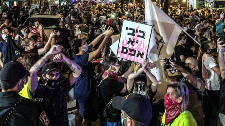 Police attempt to stop the demonstration on Ben Yehuda Street in Central Tel Aviv on Wednesday night, September 30. The small sign in the foreground reads: "Bibi, you're a nothing."