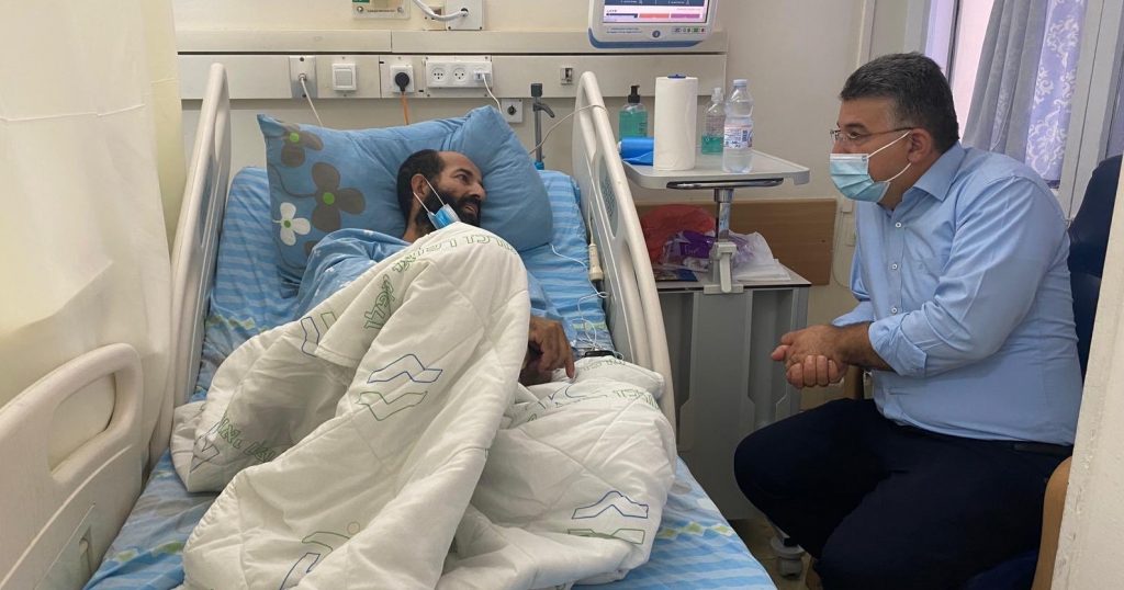 Hunger-striking Maher Al-Akhars converses with MK Youssef Jabareen during a visit by the latter at the Kaplan Medical Center in Rehovot, October 6.