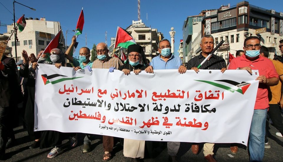 Palestinians protest against the "Arab normalization" in Ramallah, West Bank, following the signing of the US-Israeli-UAE deal, August 15, 2020. The banner reads "The UAE's normalization agreement with Israel is a reward for the occupation and settlement state and a stab in the back of Jerusalem and Palestine," and is signed "The National and Islamic Forces – Ramallah and al-Bireh Governate."