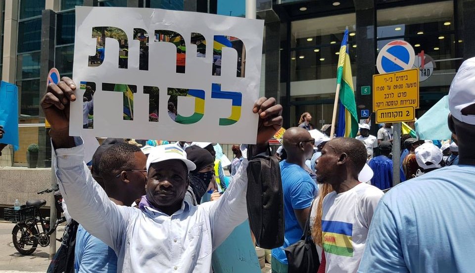 Sudanese asylum-seekers demonstrate in Tel Aviv in solidarity with the popular ongoing struggle for democracy in their country, June 2019. The sign in Hebrew held aloft reads "Freedom for Sudan."