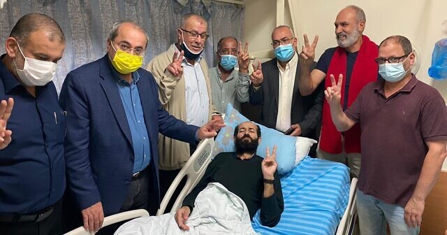 Parliamentarians from the Joint List and former MK Mohammed Barakeh (third from left) gather in Palestinian detainee Maher al-Akhras’s room at Kaplan Hospital in Rehovot, on November 6, 2020 to wish him well on the end of his hunger strike.