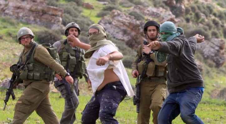 Israeli settlers from a "wildcat outpost" attack Palestinians in the occupied West Bank while soldiers merely look on.