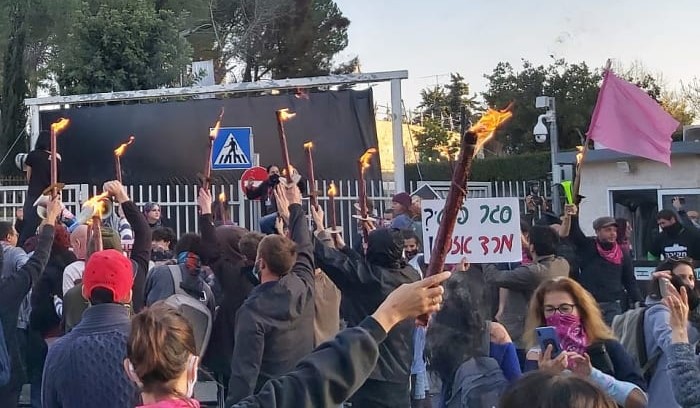 Several hundred people protest outside the compound housing far-right Prime Minister Benjamin Netanyahu's official residence on Balfour Street in Jerusalem, Saturday, December 27. Note the black curtain that had been erected behind the entrance gate which protestors called to bring down. The small sign in center right reads: "Private lockdown? Civil rebellion!"