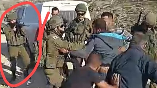 This is a frame from the video clip (length, 2:20) of the incident during which Haroun Abu Aram was critically shot at close range by an Israel soldier, circled in red. The tape shows what initially looked like a rift between soldiers and Palestinians over a generator. None of the Palestinians was armed. Then, at 1:54 into the tape, a gunshot is heard, the camera is jostled and points to the ground before returning to the scene, where Abu Aram can now be seeing lying on the ground critically wounded, Friday, January 1, 2021.