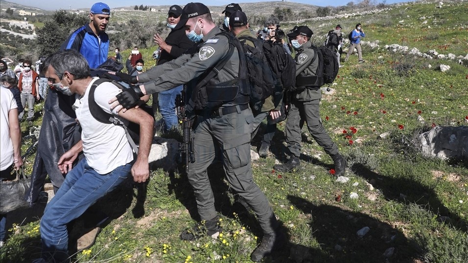 Israeli Border Police disperse Palestinian farmers and Israeli activists from a field threatened with confiscation, belonging to the village of Burin, Friday, February 12, 2021.
