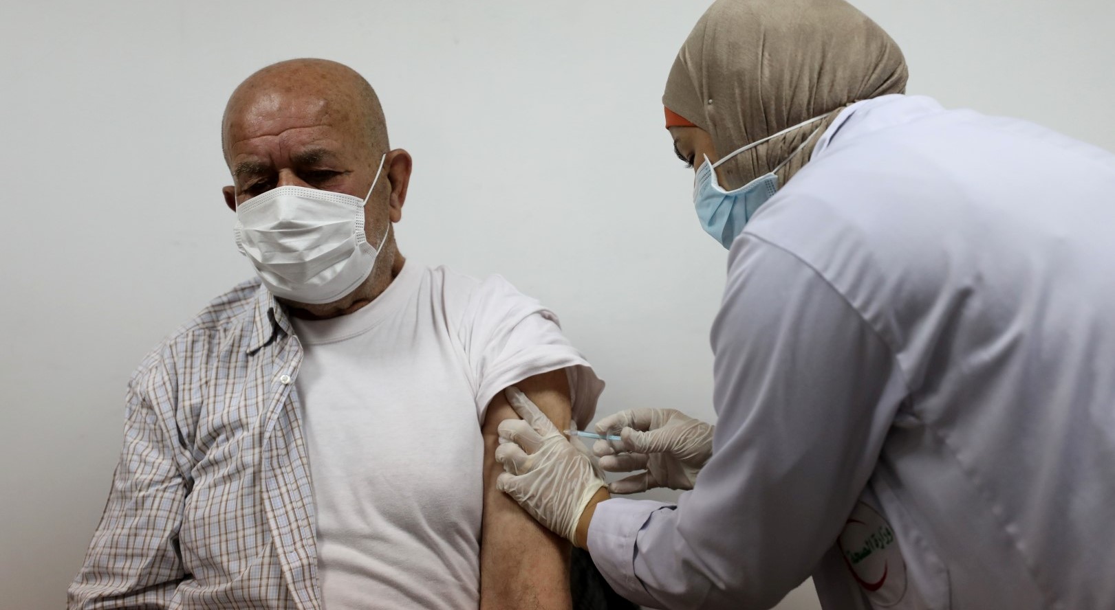 A Palestinian resident of the West Bank receives a vaccination against COVID-19.