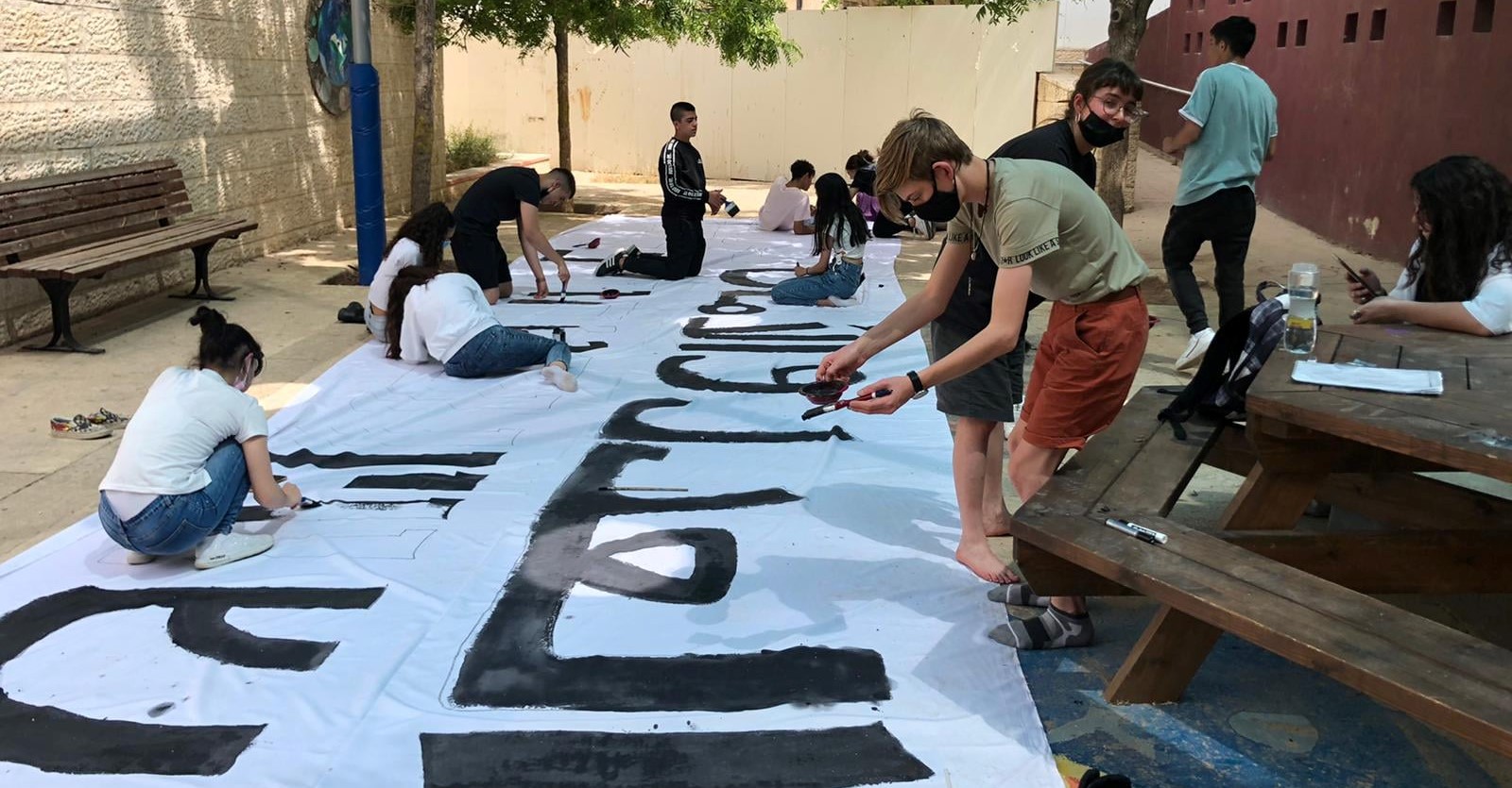 Preparing for a mass demonstration for Jewish-Arab solidarity and coexistence, pupils from the Yad b’Yad school in Jerusalem paint a huge banner in Hebrew and Arabic: "Equality and security for all Jerusalem residents."