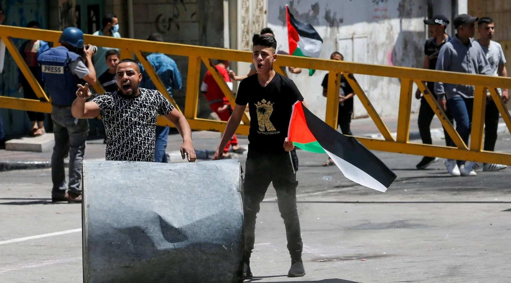 Palestinian demonstrators in the city of Hebron, Friday, May 14