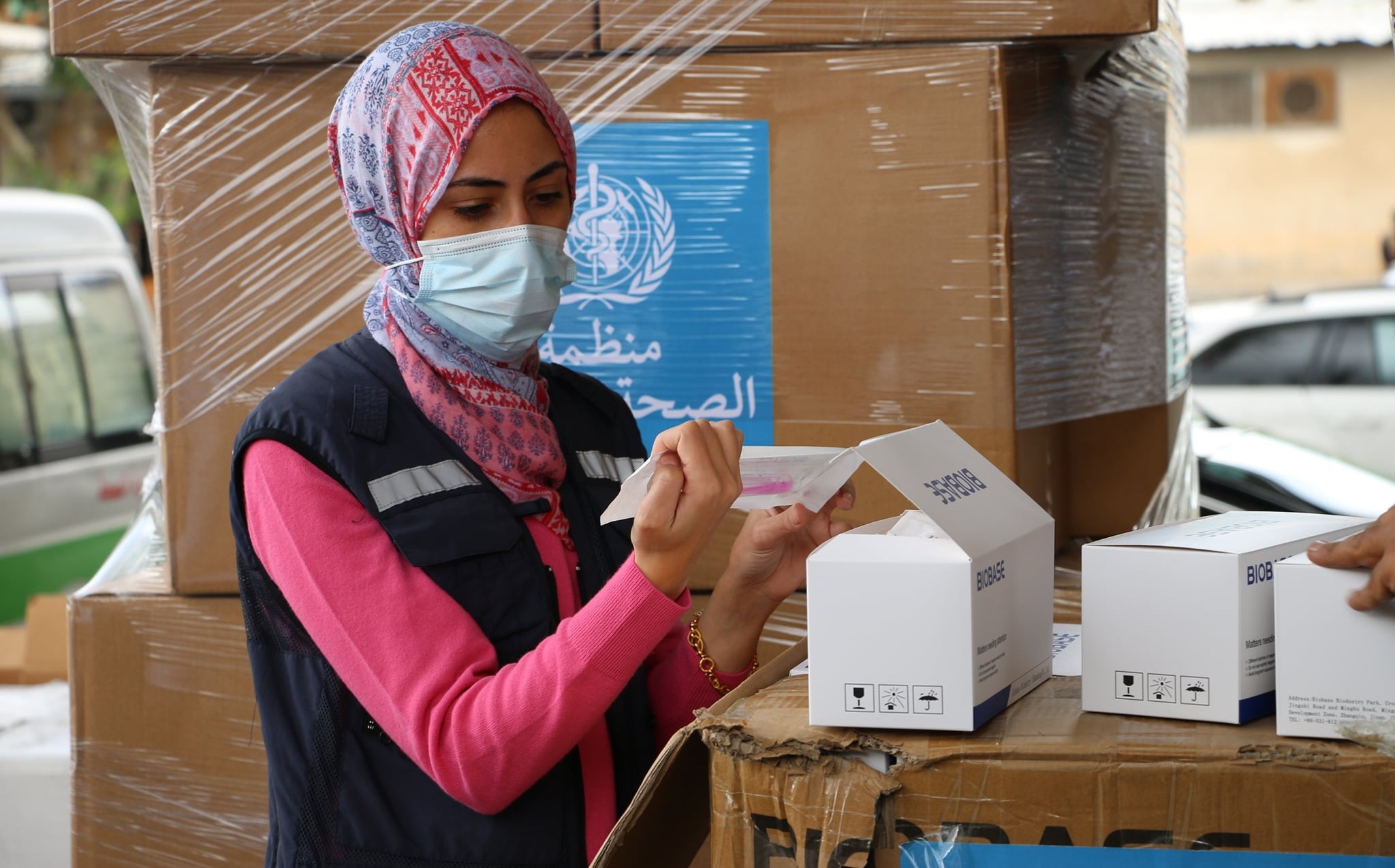 A Palestinian health worker in the West Bank examines medical aid materials provided to the Palestinian people by the UN.