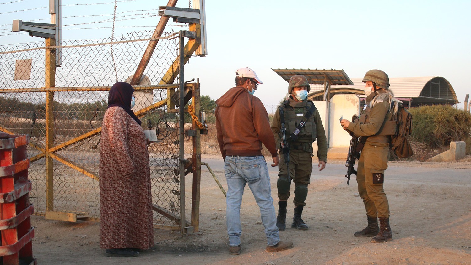 Occupation soldiers verify the identity of Palestinian farmers in the West Bank.
