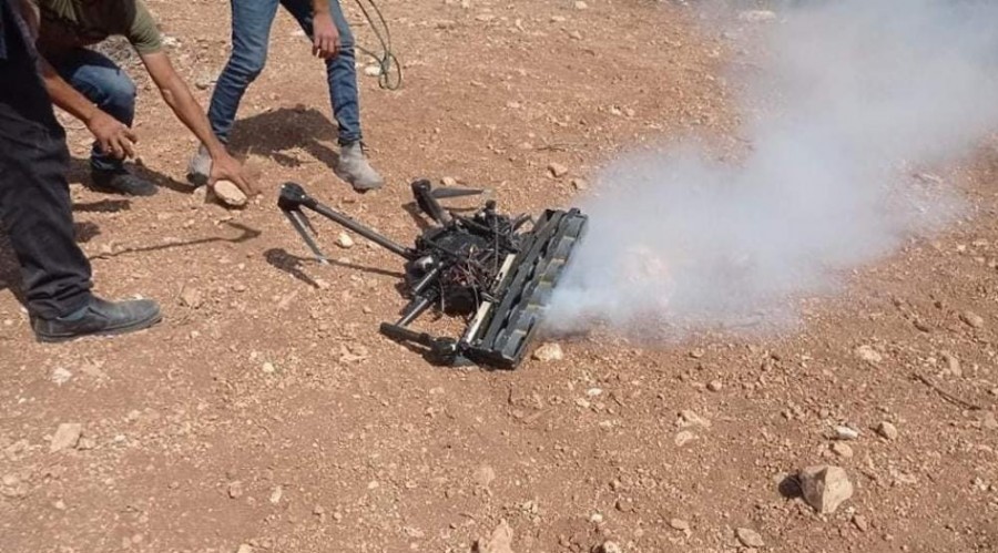 Palestinian protestors approach the Israeli quadcopter that had been dropping tear gas on them after downing it on Friday, October 1, in Beita in the occupied South Hebron Hills.