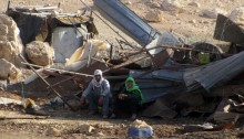 Residents of Khirbet Makhul next to their demolished homes. September 16, 2013