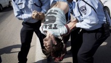 Policemen arrest an activist outside Israeli cabinet session at Kibbutz Sde Boker during a protest against the demolition of Umm al-Hiran to make room for a Jewish settlement in their place, November 10, 2013 (Photo: Activestills)
