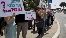 Protest against forced feeding of Palestinian prisoners, Jerusalem, June 16, 2014. Activists and doctors take part in a demonstration, organized by Physicians for Human Rights organization, against the bill to legalize forced feeding of hunger-striking prisoners in Israel, in front of the Knesset. Sign in Hebrew reads: "Judge, what is legal in administrative detention?" and in English and Arabic: "Force Feeding = Torture." (Photo: Activestills)