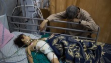An injured Palestinian child lies in Al Shifa Hospital in Gaza City following an attack on an UNRWA school in Jabaliya, July 30, 2014 (Photo: Activestills)