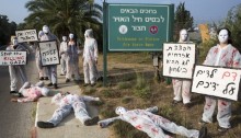 Israeli women peace activists staging a protest against the attack on Gaza at Hatzor Air Force base, Israel, July 29, 2014. The activists wore white overalls stained with red paint calling on the Israeli government to stop the strikes and bring an end to the siege on Gaza, also expressing concern regarding the suffering of civilians in southern Israel. Signs in Hebrew read: "Blood of children on your hands", "Bombing civilians will not bring security", Stop the massacre in Gaza" and "Remove the siege". A few activists were detained by police (Photo: Activestills)