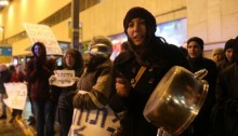 Activists protest in central Tel Aviv against the harsh conditions in the Holot prison, and against the refusal of prison authorities to allow heaters to be used there, January 10, 2015.