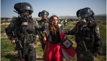 Israeli border policemen arrest a Hadash activist protester during the demonstration marking ten years of popular struggle against in the West Bank village Bil’in, February 27, 2015.