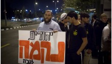 Israeli extreme right-wing activist Benzi Gopstein, leader of the Lehava organization, takes part in a protest near the tram station in East Jerusalem, October 23, 2014. The sign reads: "Jews, Revenge."