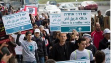 Israeli and Palestinian demonstrators, among them Joint List MK Dov Khenin (Hadash), march against the occupation and to commemorate International Women’s Day, Beit Jala, West Bank, March 4, 2016.
