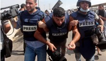 Palestinian journalists help an injured colleague get to safety after being attacked by Israeli soldiers near the Erez Crossing on October 13th 2015
