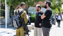 “Breaking the Silence” activists with soldiers in front of Tel-Aviv University