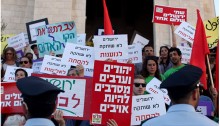 A demonstration against racism in Jerusalem – among the signs, in the foreground is one displaying one of the political slogans of Hadash’s “Jews and Arabs Refuse to Be Enemies”