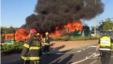 Firefighters and the two burning buses destroyed in the Jerusalem bomb blast, April 18, 2016