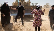 An Arab-Bedouin woman attempts to block a bulldozer in the unrecognized village of Al-Araqib, Negev Desert, July 24, 2016.