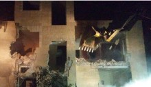 Secured by armed Israeli forces, a bulldozer destroys one of a 20 Palestinian homes demolished in occupied East Jerusalem on Monday night, July 25.