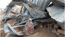 Zahrah Mahmoud Ayub, 68, from Khirbet Tall al-Himma, seated next to a structure demolished in her community by Israeli Civil Administration forces on September 27, 2016