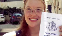 Occupation objector Tamar Alon shows off her official exemption from military service after spending a total of 130 days in military prison.