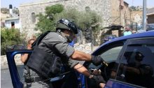 An Israeli police officer violently confronts a Palestinian resident in occupied East Jerusalem, July 21, 2017.