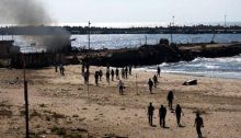 Paramedics and media crews on location minutes after the Israeli military attack on a Gaza beach front that killed the four Bakr children as they were playing football on the shorefront, July 16, 2014