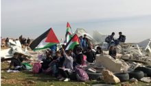 Palestinian children from the school in the Bedouin community of Abu an-Nuwar in the West Bank demonstrate seated on the ruins of their classrooms after their demolition by Israel, Sunday February 4.