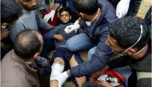 Palestinians tend to a boy who was shot in the leg by an Israeli sniper during the Great Return March in Gaza, east of the Jabaliya refugee camp, March 30, 2018.