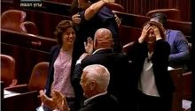 Members of the opposition cheer and congratulate one another after the bill was approved by a vote of 37 to 36.