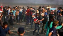 A young Palestinian demonstrator wounded by Israeli fire is evacuated from the scene along the Gaza border, Friday, July 6.