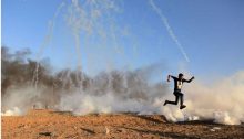 A Palestinian demonstrator runs for his life, last Friday, along the Israeli-Gaza border