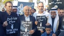 Sheikh Sayeh Abu-Madi’am (first from right) is accompanied by hundreds of supporters before his entrance into Ramle's Ma’asiyahu prison on Tuesday to begin serving a 10-month sentence for trespassing on his own land. MK Dov Khenin (Hadash, first from left) is holding one of the "We are all Sheikh Sayeh" placards distributed to demonstrators