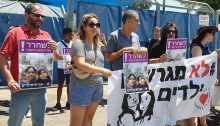 Hadash MK Ofer Cassif (first from left) during a demonstration outside the Ben Gurion Airport detention center protesting the deportation of Filipino workers and their children, Monday, August 12, 2019