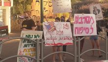 Members of the group "Youth against Annexation" demonstrate near the home of Israel's Minister of Defense, Benny Gantz, in Rosh HaAyin on Thursday, June 25. The placard in Hebrew in the right foreground reads: "Rejecting Annexation." The one with the American flag in the center, like that on the left reads: "We won't die and we won't kill in the service of the United States." The sign in Arabic (and English) held aloft in the center echoes the American profanity Gantz used earlier in the week when referring to the situation the Palestinians have allegedly made for themselves by refusing to enter into a dialog regarding the looming annexation, and reads: "The 'deep s**t' made here by war criminals like you is receding!"
