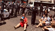 Striking social workers conduct a sit-in on Dizengoff Street in Central Tel Aviv, last Friday, July 17. The demonstrator with the megaphone is the head of the Social Workers' Union, Inbal Hermoni.
