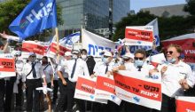 Workers from Israel's Arkia Airlines demonstrated in Herzliya last Wednesday, July 29, demanding resumption of the service by their employer. The Histradrut union produced signs held by the protestors are all directed to "Nakash," the family name of the three brothers whose group owns the airline and numerous other enterprises. In the front line at the right the text reads: "Nakash – Zionism until [it comes to reaching into your] pocket!!!"; Behind this, the poster being held aloft reads: "Nakash – Your hotels are full but we are hungry!"